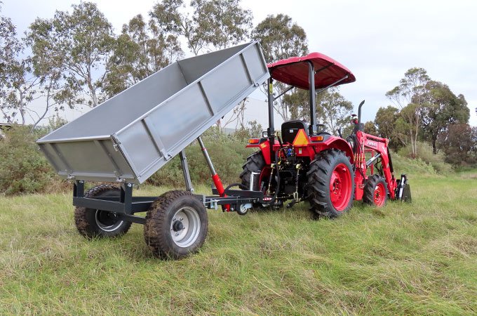 The AGMAX tipping trailer features tie-downs all around, removable sides, and hydraulic assistance.